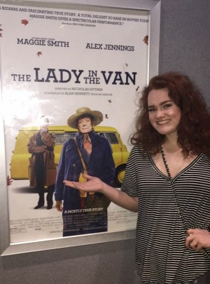Senior Megan Docherty posing in front of a movie poster at the Edina Theater